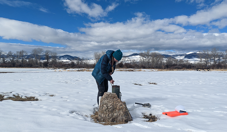 Measuring groundwater levels in the Big Hole River Valley to interpret groundwater flow directions.