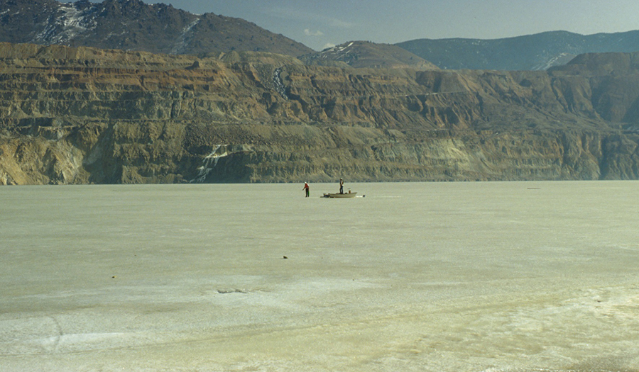 MBMG employess collecting water samples beneath ice cover on Berkeley Pit