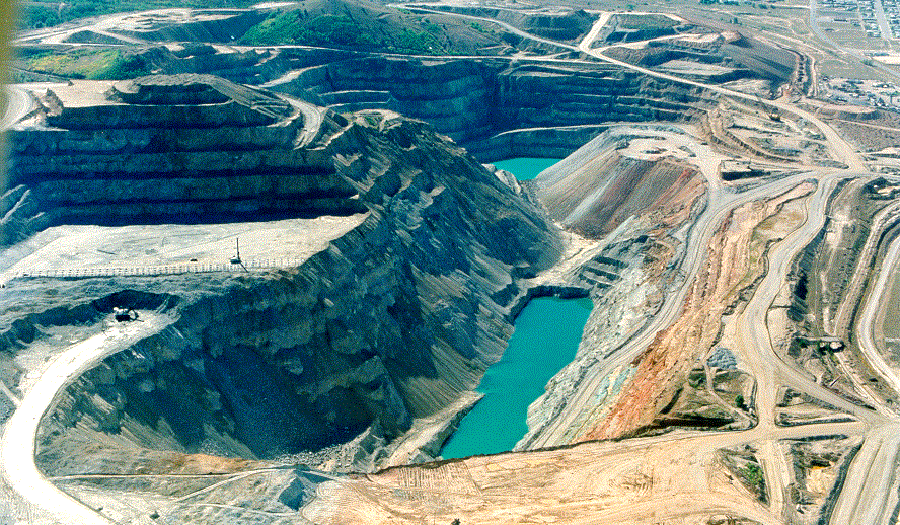 Aerial view of standing water in Continental Pit and drill on upper bench, 1995
