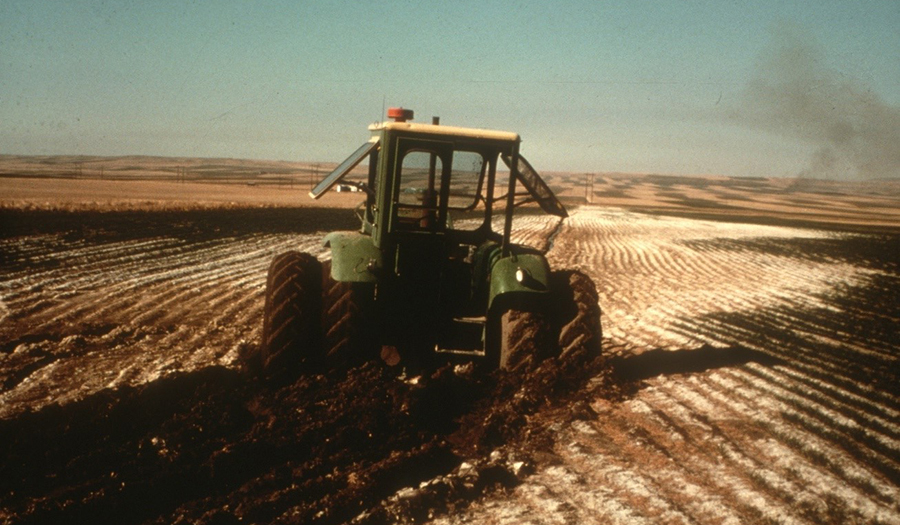 Farm tractor stuck in saline seep (dryland salinity) impacted field